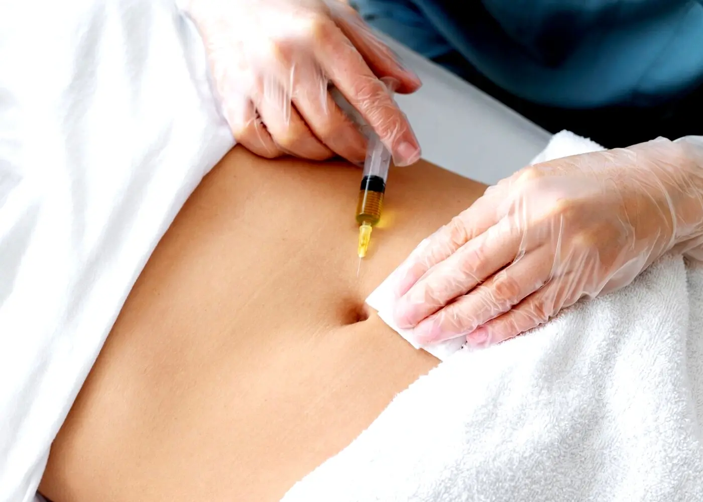 Administering a fat-dissolving injection to the abdominal area, illustrating targeted body contouring.